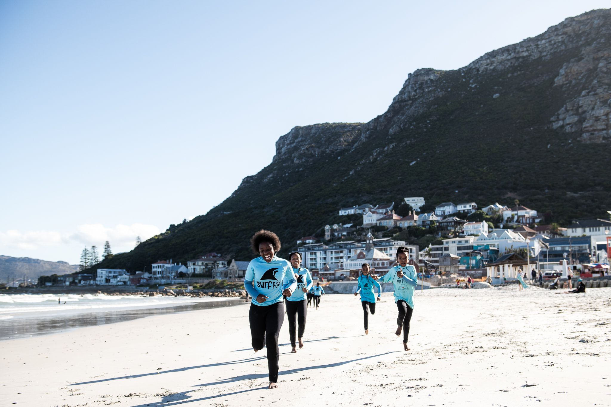Surfpop children running on the beach
